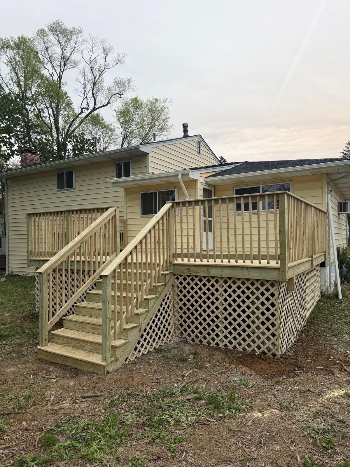 Newly built backyard deck with stairs and lattice skirting