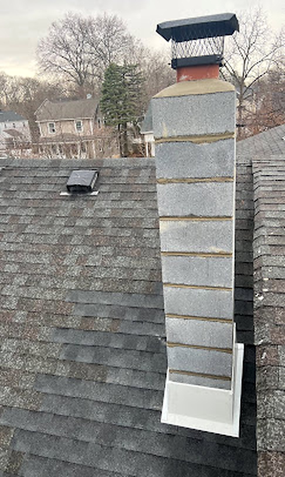 Brick chimney with new cap installation in winter
