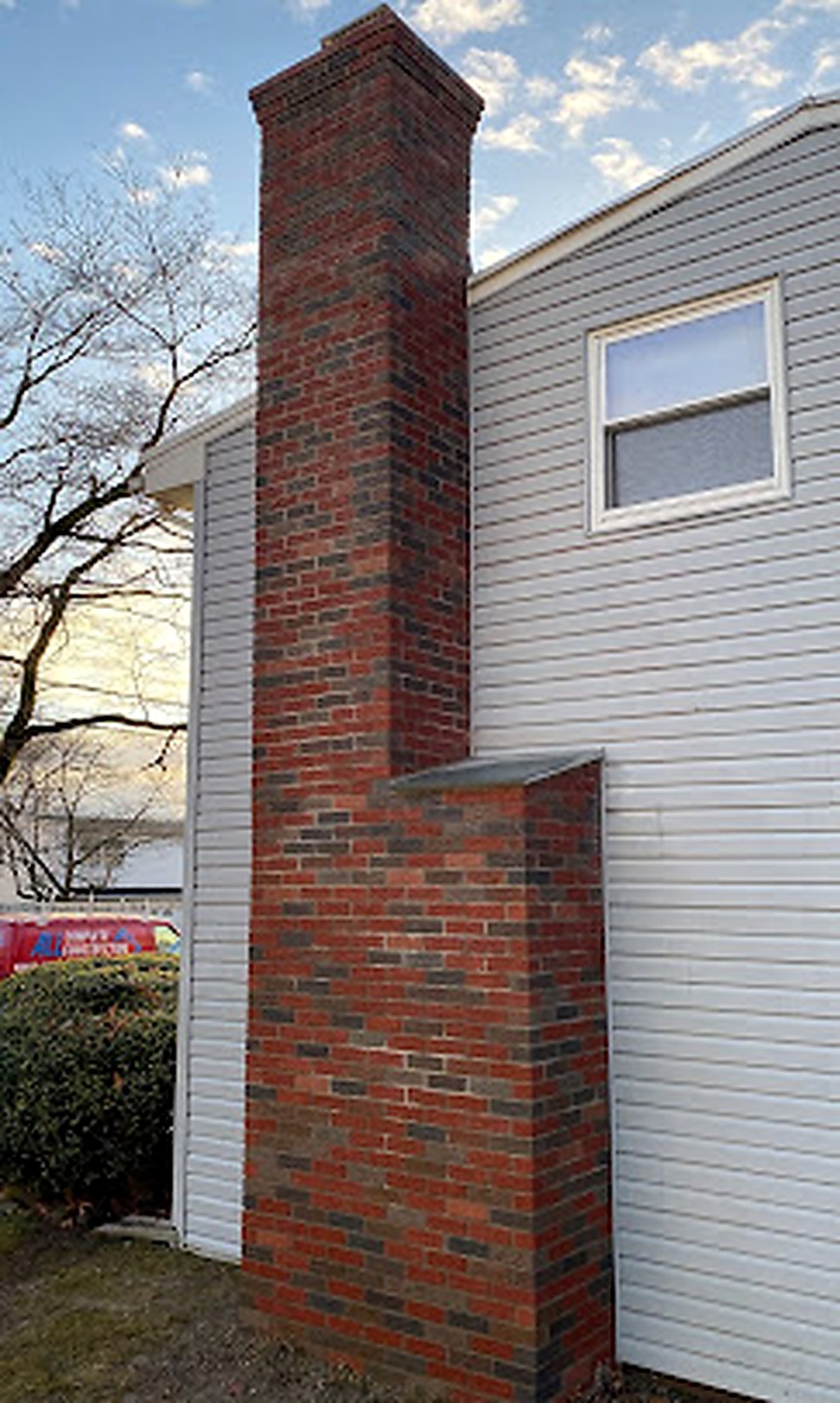 Tall rebuilt brick chimney with new cap