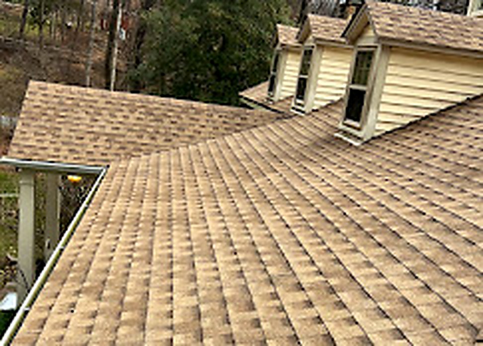 Tan architectural shingle close-up showing texture and granules
