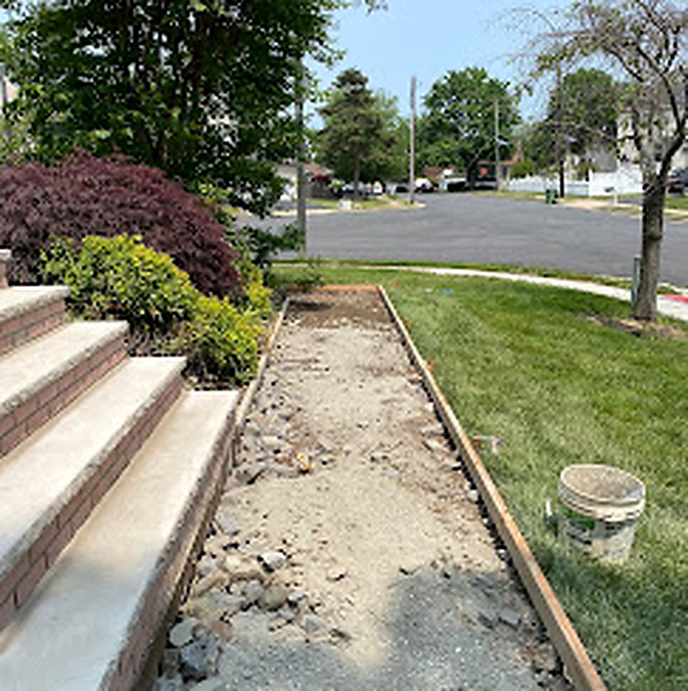 New concrete sidewalk forms set with rebar before pour