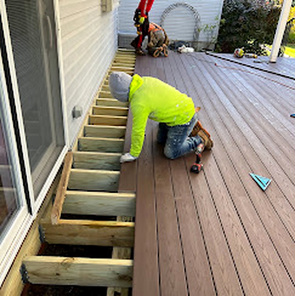 Workers installing composite deck boards in Middlesex County NJ