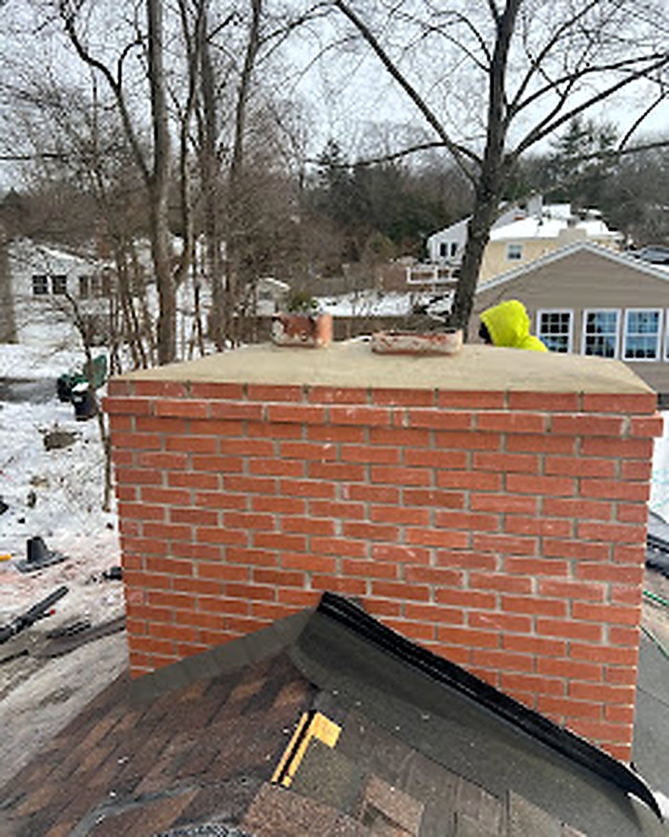 Newly rebuilt brick chimney from above, snowy conditions