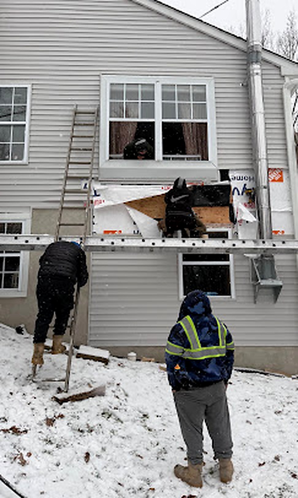 Crew in safety vests doing winter siding repair on a Central NJ home